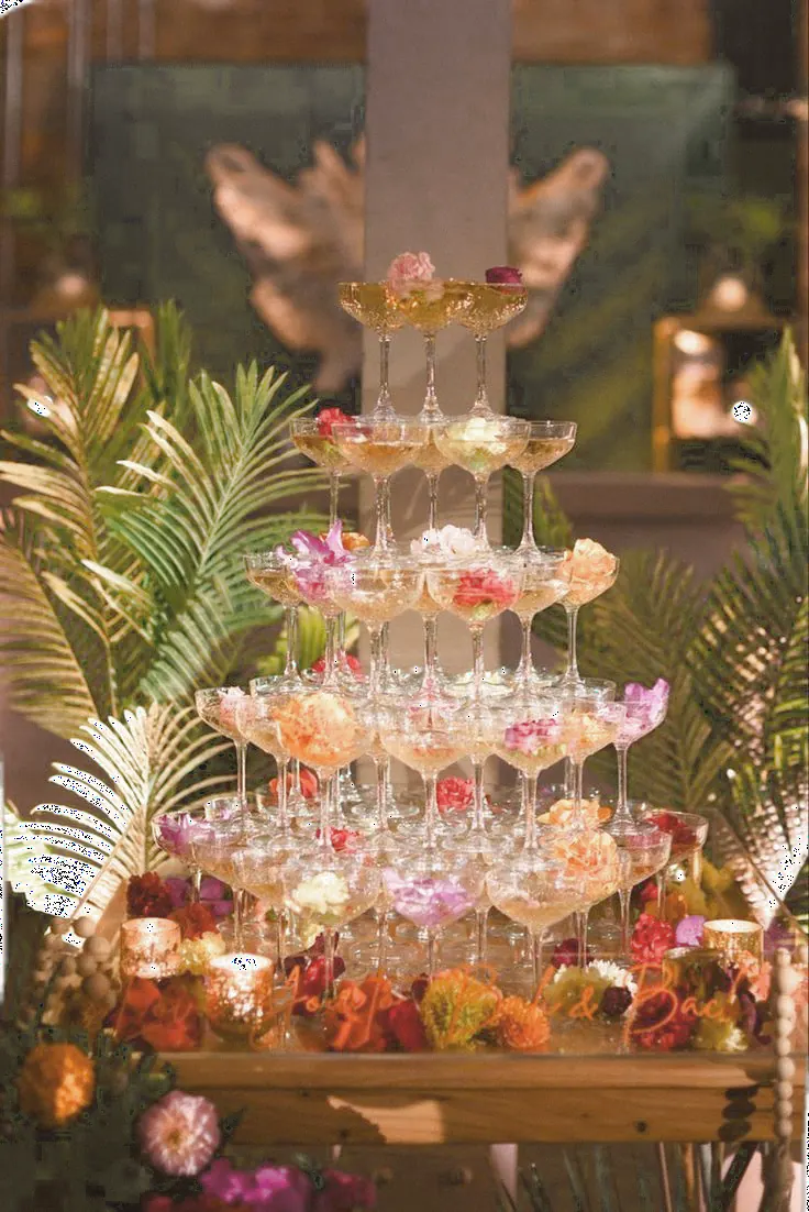 Tiered champagne tower dressed with flowers