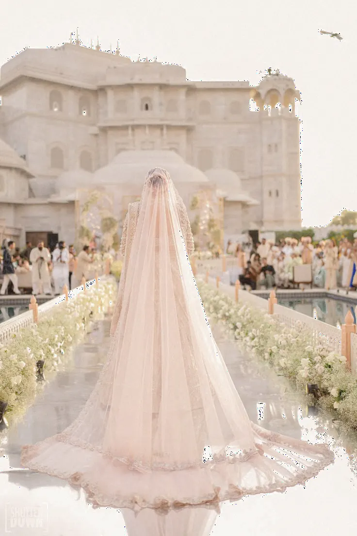 Bride Walking Along A Flower-Lined Palace Aisle